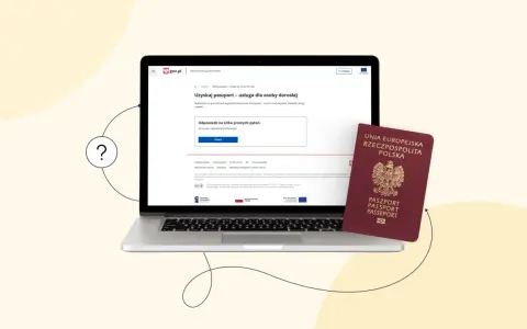Laptop z otwartą stroną gov.pl i polskim paszportem obok.