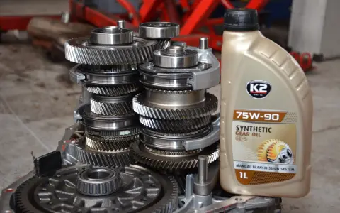 Zestaw kół zębatych skrzyni biegów i butelka oleju 75W-90. Jaki olej do skrzyni biegów? Ten syntetyczny GL-5 jest dobrym wyborem.